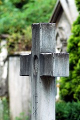 a cross stone in a cemetery in Italy