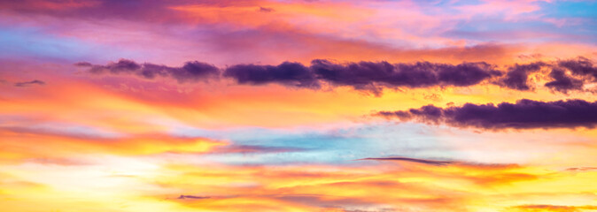 Naklejka na ściany i meble Panorama of colorful x clouds in the sunset sky