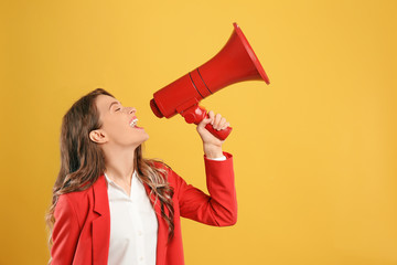 Young woman with megaphone on yellow background - Powered by Adobe