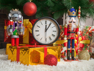 New Year's still life: antique clock, Christmas tree with toys, gifts in boxes