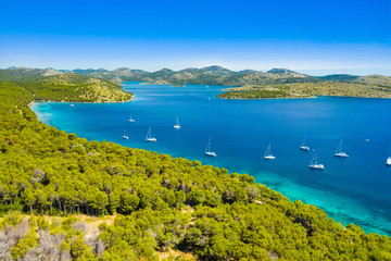 Croatia, Dugi Otok Island, aerial view of the beautiful bay in nature park Telascica, yachts anchored on shore, touristic paradise