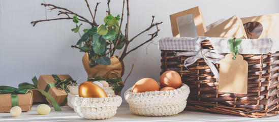 Easter zero waste, environmentally friendly gift wrapping kraft paper, eggs in a basket, gift basket, cozy religious Easter holiday, eco concept eco friendly decor banner on gray background
