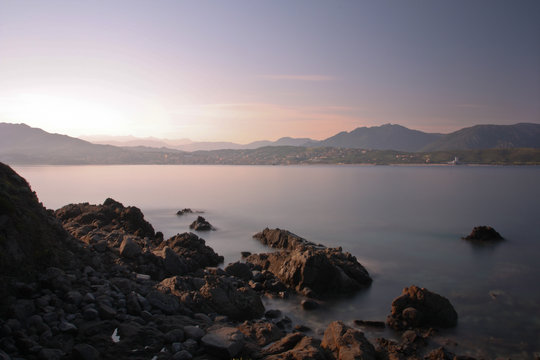 Sunrise on the isle of corsica with smooth water.