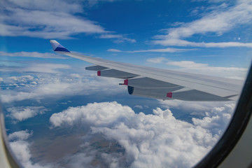 Fototapeta na wymiar Sunny aerial sky landscape from and airplane window seat
