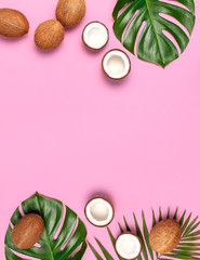 Fototapeta na wymiar Summer Flat lay background. Frame of tropical leaves and fresh coconut on pink background top view copy space. Healthy cooking. Creative healthy food concept, half of coconut, nature