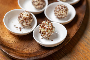 Cream cheese balls coated with white and brown sesame seeds. Tasty treat.