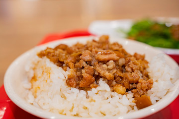Close up shot of a bowl of braised pork rice
