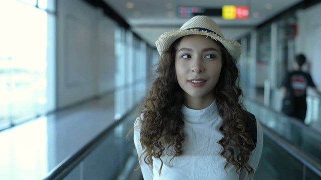 Travel concept. An Asian woman is traveling at the airport. 4k Resolution.