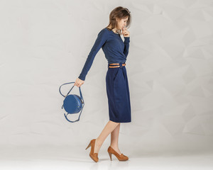 Stylish fashionable woman with blue round bag