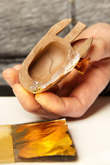 Artwork of gilding - covering an object with plate metal gold