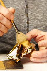 Artwork of gilding - covering an object with plate metal gold