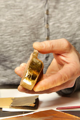 Artwork of gilding - covering an object with plate metal gold