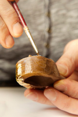Artwork of gilding - covering an object with plate metal gold