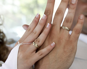 bride and groom demonstrate wedding rings at a wedding
