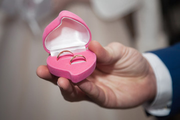 Two wedding gold rings at a wedding. Wedding rings are a symbol of love and fidelity.