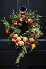 English door decorated with Christmas wreaths before Christmas