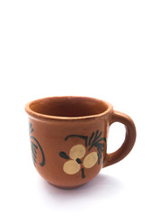 Clay cup isolated on a white background. Empty brown cup for tea and coffee. Cup with a pattern.