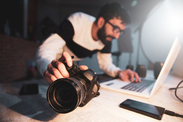 photographer hand camera with keyboard on desk