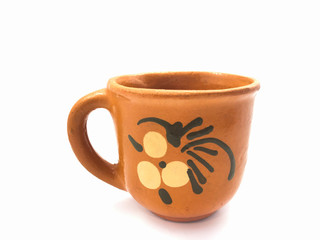 Clay cup isolated on a white background. Empty brown cup for tea and coffee. Cup with a pattern.