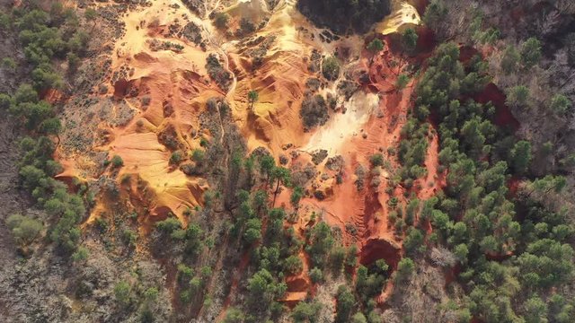 Aerial shot red soil ochre texture abstract pine trees Colorado Provencal Rustrel France