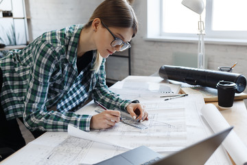 Architect drawing blueprints in office. Engineer sketching a construction project. Architectural...