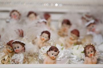 Small toys angels (girls and boys) decorated with beads, feathers and pearls