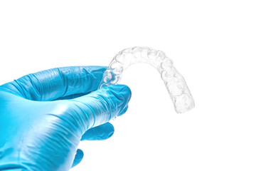 Hand holding individual dental tray for bleaching teeth