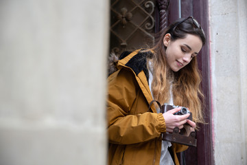 Photo of young tourist girl exploring streets of Baku. Moody photos of teenager girl visiting old city and taking photos of the city