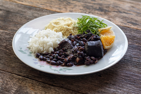 Brazilian feijoada food - Wooden background