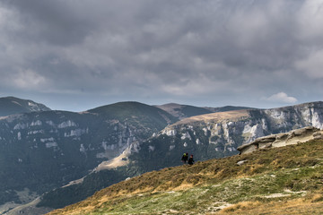 Fototapeta premium a beautiful mountain landscape. Somewhere in the distance two tourists are seen climbing. An autumn day on the mountains