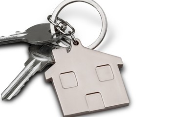 House keys with house figure on desk