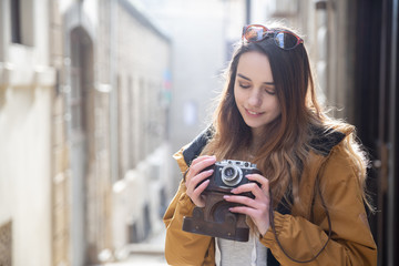 Photo of young tourist girl exploring streets of Baku. Moody photos of teenager girl visiting old city and taking photos of the city