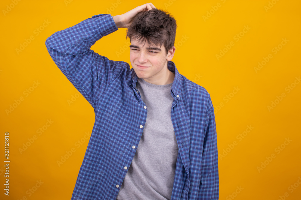 Poster young teenager boy or student isolated on yellow background