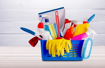 Plastic bottles, cleaning sponges and gloves on desk