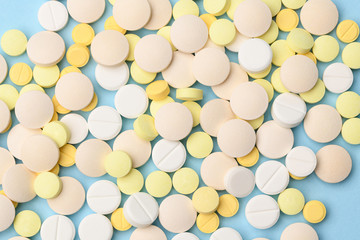 yellow and white tablets on a blue background close up