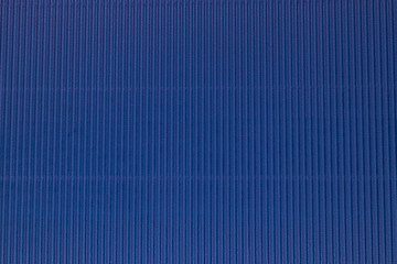 Corrugated blue color paper background texture, copy space, template. Colorful background, corrugated paper cardboard, copy space, template.