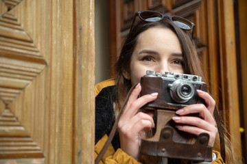 Photo of young tourist girl exploring streets of Baku. Moody photos of teenager girl visiting old city and taking photos of the city