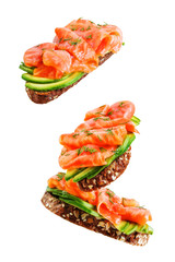 Smoked salmon avocado rye sandwich on a white isolated background