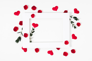 Elegant composition for Valentine's Day. Empty paper blank, red hearts, rose petals on white background. Valentine day, 8th march, Mother day background. Love concept. Flat lay, top view, copy space