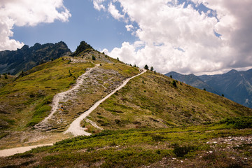 Stunning mountain panorama with hiking trails high up in the Pennine Alps on a cloudy day in summer. Saint-Luc, Valais, Switzerland