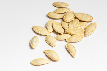 Pumpkin seeds or pepitas, isolated on white background. Top view. Flat lay