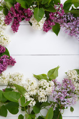 Bouquet of lilac flowers on white wooden background. Surprise for lovely woman. Natural spring style. Aromatherapy.  Flowers Flat lay, top view. Spring blossom mood. Background with copy space