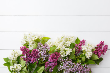 Bouquet of lilac flowers on white wooden background. Surprise for lovely woman. Natural spring style. Aromatherapy.  Flowers Flat lay, top view. Spring blossom mood. Background with copy space