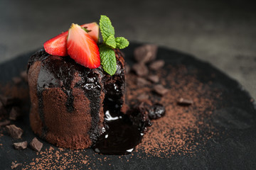 Delicious warm chocolate lava cake on slate board, closeup. Space for text