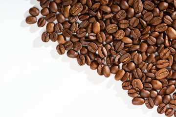 Coffee beans on a white background with place for text.