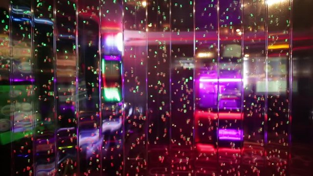 colored air bubbles in water on a transparent wall of the interior in a nightclub or casino