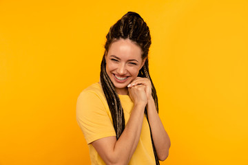 Fototapeta premium Glad pleased happy young woman in the yellow studio