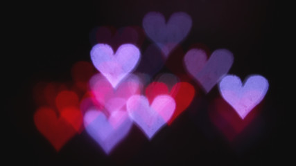 Colorful bokeh on a black background, in the form of heart