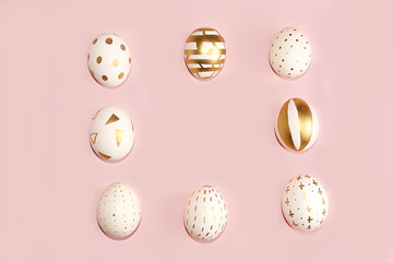 Decorated golden easter eggs on a pink background. Minimal holiday concept. Happy easter background. Creative painting of eggs at home, the idea of simple drawings for coloring,