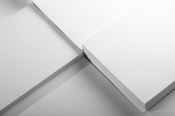 Several stacks of white paper on a white background